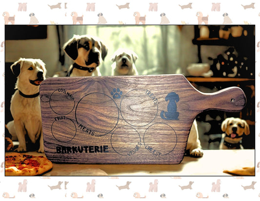 Wooden cutting board with 'Barkuterie' branding in front of dogs in a kitchen setting