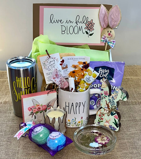 A collection of Easter-themed items including a bunny-themed popcorn bucket, chocolate eggs, a framed 'Happy Easter' sign, and other assorted Easter treats.