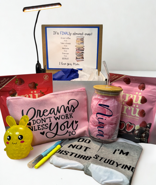 Collection of study-related items including a pink pouch, jar, and stationery on a white surface.