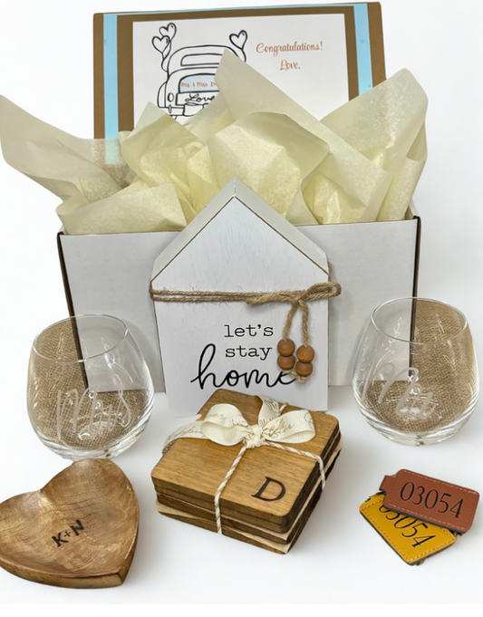 Gift set with glasses, coasters, and a card on a white background