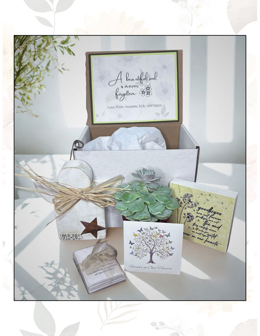 Memorial gift set with cards, plants, and other items on a white surface.