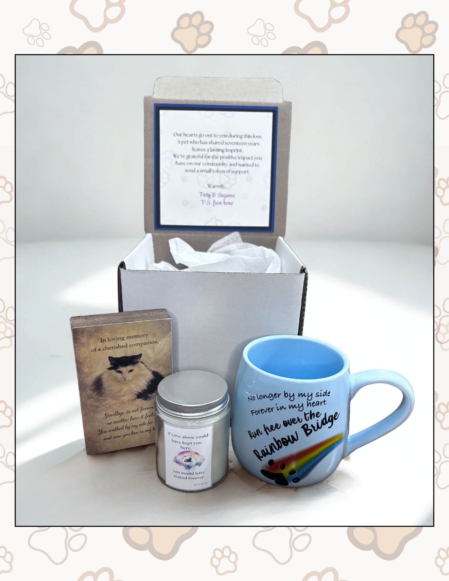 Gift set with mug, book, and candle in a box on a white background